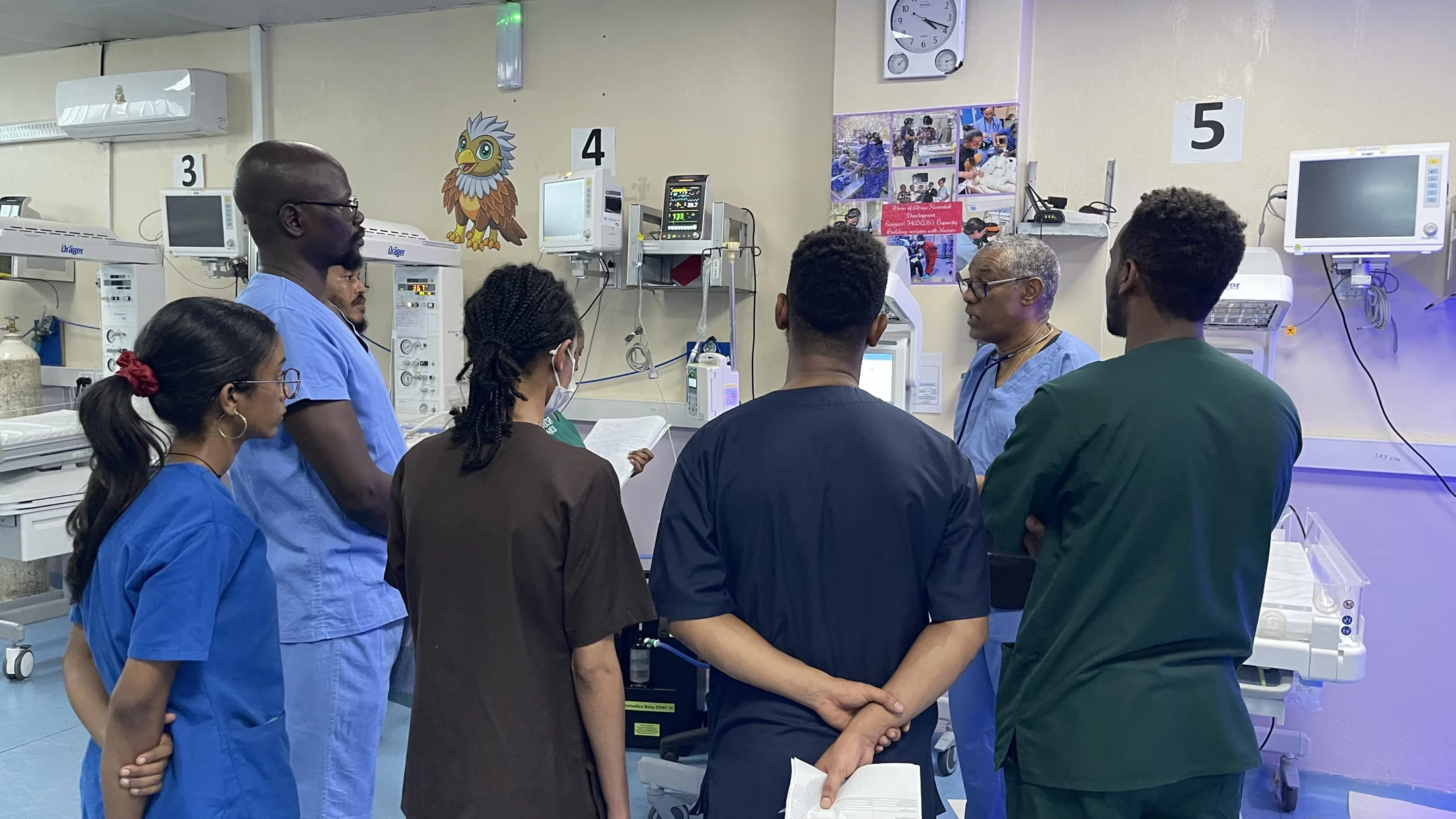 Medical professionals sharing knowledge in the neonatal unit