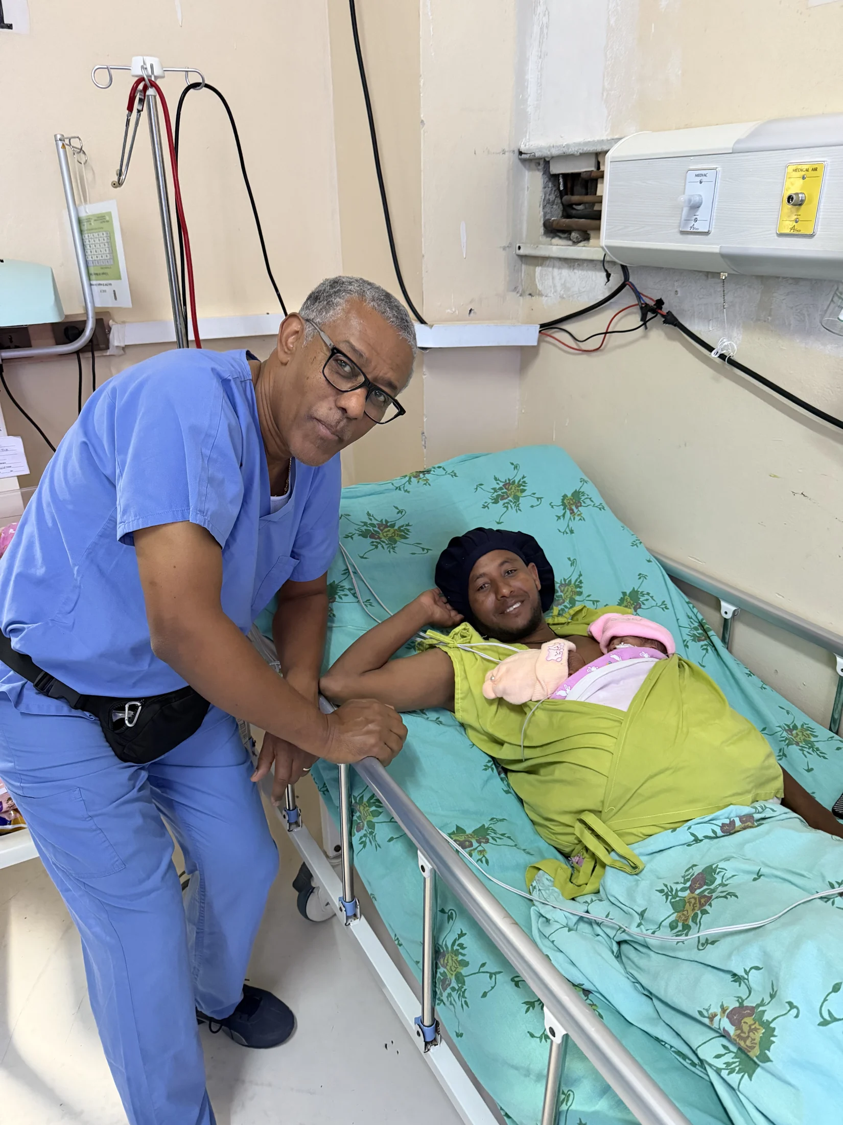 A medical professional at a patient’s bedside